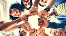 a group of people holding hands in the shape of a circle with their fingers together