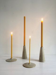 three candles are placed in the shape of cones