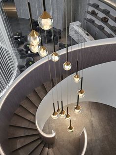 a spiral staircase with lights hanging from it