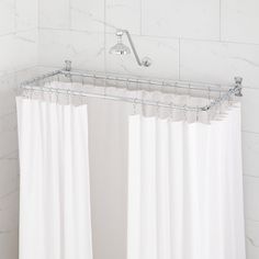 a white shower curtain in a bathroom