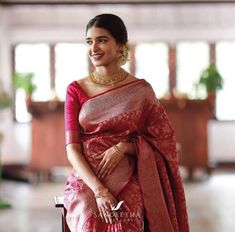 a woman in a red and gold sari