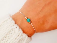 "Choose something unique made just for you. Beautiful bracelet, in the color of your choice, with turquoise gemstone. Side beads and finish is available in two colors, silver or gold. A very cute everyday bracelet, fit on all wrists. Made with color string and macrame slide lock closure. You can wear it alone or layer it with other pieces. Turquoise takes on the characteristics of the owner. This stone is a very personal and meaningful stone to one who wears it. Turquoise is a master healing sto Minimalist Turquoise Bracelet For Gift, Minimalist Turquoise Bracelet For Friendship, Handmade Minimalist Turquoise Bracelets, Adjustable Minimalist Turquoise Jewelry, Meaningful Stone, Bracelet Bff, Bff Gift, Everyday Bracelet, Slide Lock