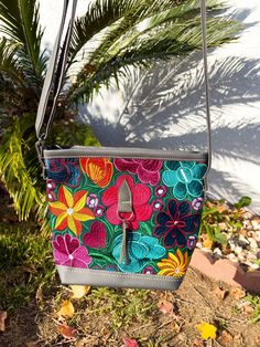 *Please advise each bag has a different design and color background. It might not be the exact flowers/ color background as the image. If you want a specific design please message us for photos*  The vibrant embroidered flowers that are carefully crafted by artisans in Mexico bring beauty to this bag. You can style this as a shoulder or crossbody bag for any occasion. Measurements: 10 inches (width) x 8 1/2 (length) Made with Synthetic Faux Leather -Adjustable straps -Zipper closure pocket -Back Brown Cafe, Embroidered Purse, Flowers Color, Navy And Brown, Embroidered Bag, Color Background, Colour Star, Embroidered Flowers, Colorful Flowers