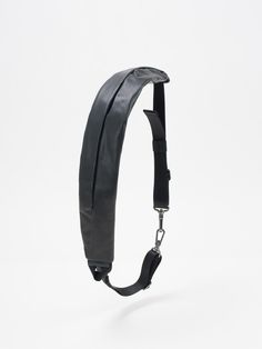 a black strap is attached to the back of a headband on a white background