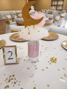 the table is decorated with gold stars and white linens, which are accented with sequins