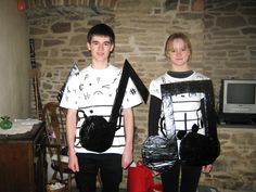 two young boys dressed up in paper machs and carrying bags, standing next to each other