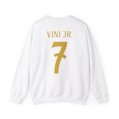 Stay warm and cozy while showing your support for Vinicius JR and Real Madrid with this unisex sweatshirt. Perfect for fans of the talented footballer, this sweatshirt is made from a medium-heavy fabric blend of cotton and polyester, providing comfort and warmth during the colder months. The classic fit and clean-cut style make it a versatile piece for everyday wear, while the ethically sourced materials ensure a guilt-free purchase for eco-conscious consumers. Ideal for wearing to football matc Fan Gear Sportswear Hoodie With Crew Neck, Sportswear Long Sleeve Sweatshirt For Fans, Long Sleeve Sportswear Sweatshirt For Fans, Sports Fan Apparel Sweater With Crew Neck, Sporty Crew Sweatshirt With Team Logo, Sports Season Fan Merchandise Sweatshirt, Sportswear Sweatshirt For Fans During Sports Season, White Varsity Crew Hoodie, White Fan Apparel Sweatshirt For Streetwear