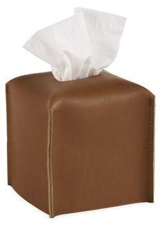 a brown leather tissue dispenser with white tissue in it's holder