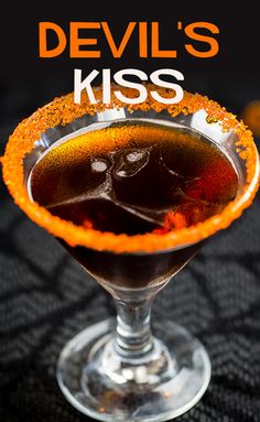 the devil's kiss cocktail in a coupe glass with orange sprinkles