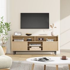 a living room with a large television mounted on the wall and a coffee table in front of it