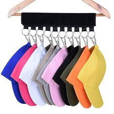 six pairs of hats hanging from a rack on a hanger with clippings