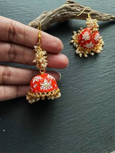 These are purely hand painted dangling meenakari Royal Indian bridal earrings in gold with Pearl drops  A  metal earrings in gold with   Meenakari &  pearl drops. Available in Orange & gold Pearl drop meenakari earrings Grey & gold Pearl drop meenakari earrings. These are an authentic Indian traditional earrings that could be worn by both traditional and an western attire. Note: The product shipped will be same as shown in the picture however, actual colours may vary slightly from those shown due to lighting in the photography. Pls note The shades of gold / silver may vary slightly. We do not accept any returns or refunds.However in case of any issue we will definitely try and resolve it! Orange Earrings Indian, Luxury Meenakari Temple Jewelry Pearl Earrings, Bridal Earrings Indian, Indian Bridal Earrings, Jumka Earrings, Meenakari Earrings, Royal Indian, Earrings Indian, Traditional Earrings