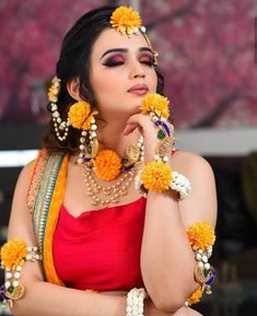 a woman with flowers in her hair and jewelry