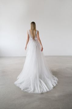 a woman in a white wedding dress looking back