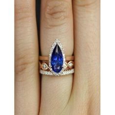 a woman's engagement ring with a blue sapphire and diamond band on her finger