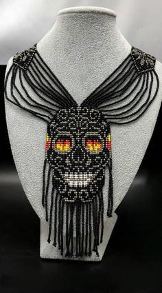 A very Beautiful  Handmade Skull Necklace  . Every beads  speak his own wonderful art . All seeds are very carefully threaded. We are sure this beautiful necklace enhance your beauty even more . Earring is with Necklace. Measurements. 50 cm long. width of chain 3cm. skull face width 5.5 cm  and length 14 cm. and.  Earring is 10 clong  and width 2.5 cm. Unique Handmade Skull Necklace, Traditional Black Jewelry With Bead Caps, Handmade Bohemian Jewelry For Halloween, Bohemian Necklaces For Halloween Jewelry Making, Black Bohemian Necklaces With Bead Caps, Bohemian Black Necklaces With Bead Caps, Beaded Jewelry For Halloween Festival, Unique Handmade Halloween Necklaces, Handmade Black Beaded Necklace For Halloween