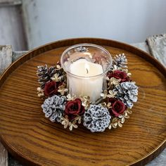 a candle is sitting on top of a wooden tray