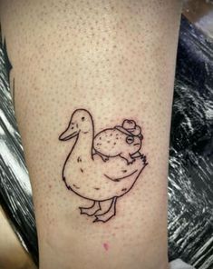 a small tattoo on the leg of a person with a duck and chicken in it