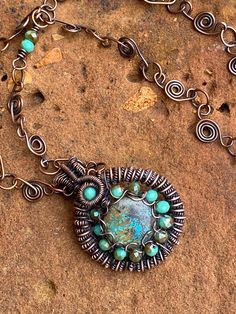 "One of my favorite stones is turquoise. This beautiful round Arizona cabochons does not disappoint. Surrounded by a heady wrap and Czech beads, making this a stunning piece. Pendant hangs on of my new chain designs. Pendant is 1 1/2\" diameter. Chain is 24\".  Beautiful for all seasons Free shipping  to USA" Bohemian Oval Chrysocolla Jewelry, Artisan Hand Wrapped Jewelry With Round Pendant, Artisan Hand Wrapped Round Pendant Jewelry, Artisan Hand-wrapped Round Pendant Jewelry, Unique Round Turquoise Necklace, Unique Turquoise Round Necklace, Round Chrysocolla Cabochon Jewelry, Unique Round Turquoise Necklaces, Turquoise Wire Wrapped Round Jewelry