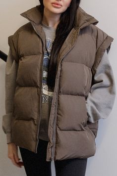 Dark Brown Puffer Vest Brown Winter Puffer Jacket With Pockets, Casual Brown Winter Vest, Casual Brown Vest For Winter, Fall Streetwear Vest, Trendy Beige Winter Vest, Fall Streetwear Solid Color Vest, Solid Color Fall Streetwear Vest, Trendy Oversized Vest, Brown Winter Vest Outerwear