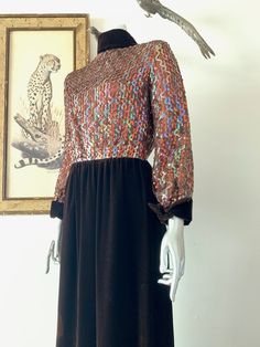 "Amazing 1970s red carpet gown! The sparkly, sequined bodice in the centerpiece to a classic brown velvet rolled high collar, long cuffed sleeve, and straight maxi skirt. Iridescent sequins sewn in vertical wavy design on bodice. High rolled collar with points down the back. Cuffs mirror the collar design. Velvet spine detail with back zip. Hook/eye closures at back neck. Snap closures on cuffs. Bodice is lined with netting. Skirt is lined with with satin. Labelled vintage size 8, but please com Embellished Maxi Dress For Formal Fall Events, Embellished Maxi Dress For Formal Fall Occasions, Glamorous Fall Sequined Maxi Dress, Glamorous Sequin Maxi Dress For Fall, Formal Sequined Maxi Dress For Fall, Fall Sequin Long Sleeve Maxi Dress, Fitted Sequin Maxi Dress For Fall, Embellished Maxi Dress For Fall, Embellished Fall Maxi Dress