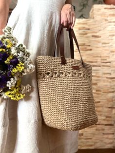 A large and elegant knitted jute bag with leather handles.. It is versatile and will suit many styles of clothing. You can also take it to the grocery store. A knitted bag will be a great gift for a girlfriend, wife or mother. The bag is made of natural jute material, so it has a special energy. Bag dimensions: 20*20*30 cm. Handle lengths: 50 cm Casual Jute Straw Bag For Shopping, Natural Fiber Shopping Bags, Chic Crochet Jute Bag With Leather Handles, Chic Jute Crochet Bag With Leather Handles, Chic Jute Crochet Shopping Bag, Chic Crochet Jute Bag For Shopping, Chic Jute Crochet Bag For Shopping, Bohemian Everyday Jute Shoulder Bag, Everyday Bohemian Jute Shoulder Bag