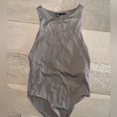 a women's gray one piece swimsuit laying on the floor