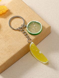 a slice of lemon sitting on top of a keychain