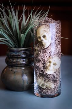 there are two vases that have skulls in them