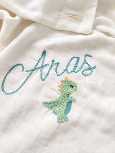 an embroidered shirt with the word'arras'written in cursive font