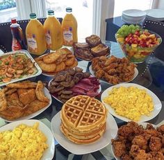 a table topped with lots of different types of breakfast foods and drinks on top of plates