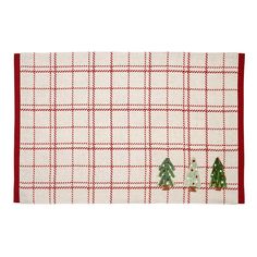 three small christmas trees on a red and white checkered placemat with two matching napkins