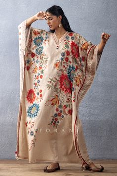 Beige kaftan with botanical digital print, V neckline and tassel border.
Components: 1
Pattern: Printed
Type Of Work: Digital Print
Neckline: Scallop
Sleeve Type: Flared
Fabric: Slub Cotton, Cotton Silk
Color: Beige
Other Details: 
Tassel and scallop border
Occasion: Resort - Aza Fashions Festive V-neck Kaftan With Floral Print, Festive Bohemian Floral Print Kaftan, Bohemian Floral Print Kaftan For Eid, Bohemian V-neck Kaftan With Printed Motifs, Festive Bohemian Kaftan With Digital Print, Festive Bohemian Kaftan With Floral Print, Traditional Digital Print Tunic Kaftan, Spring V-neck Kaftan With Digital Print, Multicolor V-neck Kaftan With Floral Embroidery