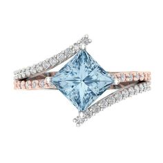 a blue topazte and diamond ring with two bands on each band, set in 18k rose gold