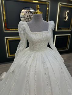 Regal Wedding Dress with Square Neckline and Beaded Long Sleeves - Larosabride's Exclusive Fitted Long Sleeve Wedding Dress For Reception, Elegant Wedding Dress With Pearl Embroidery For Debutante Ball, Long Sleeve Wedding Gown With Pearl Embroidery, Elegant Bridal Dresses With Pearl Embroidery, Elegant Long Sleeve Embellished Wedding Dress, Wedding Gown With Fitted Bodice And Square Neck, Long Sleeve Wedding Dress With Fitted Bodice For Ceremony, Modest Princess Wedding Dresses, Modest A Line Wedding Dress