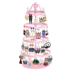 a pink jewelry rack with lots of earrings on it