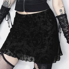 This Gothic Pattern Mesh Overlay Mini Skirt exudes alternative aesthetics with a touch of sophistication. The intricate Gothic pattern mesh overlay adds texture and depth, while the lettuce hem and above-the-knee length create a flattering silhouette. Crafted from a luxurious blend of polyester and spandex, this skirt offers both comfort and style, making it a must-have for those who embrace a bold and edgy look. Mesh Mini Skirt For Spring, Black Mesh Fitted Mini Skirt, Fitted Black Mesh Mini Skirt, Black Sheer Mini Skirt, Fitted Mesh Mini Skirt, Gothic Lined Mini Skirt For Summer, Gothic Summer Mini Skirt With Lining, Gothic Lined Skirted Bottoms, Gothic Lined Mini Skirt For Spring