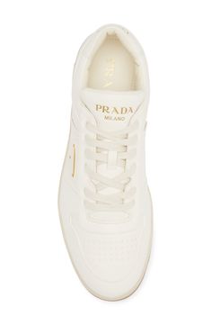 A monochrome palette lends clean minimalism to a lambskin-leather low-top sneaker featuring a perforated toe and three versions of the iconic Prada logo. Lace-up style Removable insole Leather upper and lining/rubber sole Made in Italy Designer Shoes Classic Calf Leather Sneakers With Logo, Modern Low-top Sneakers With Logo Plaque, Luxury White Sneakers With Logo Plaque, Modern Calf Leather Sneakers With Logo Plaque, Modern Calf Leather Sneakers With Logo, White Sneakers With Logo Plaque For Streetwear, Modern White Sneakers With Logo Plaque, Luxury Calf Leather Sneakers With Perforations, Luxury Perforated Calf Leather Sneakers