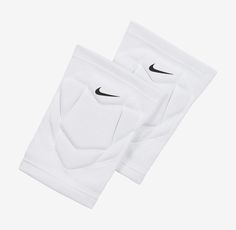 two white knee pads with black nike logo