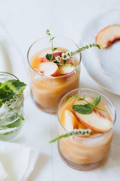 three glasses filled with drinks and garnished with orange slices