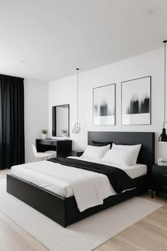 a white and black bedroom with pictures on the wall