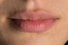 a woman's lips are shown with no makeup