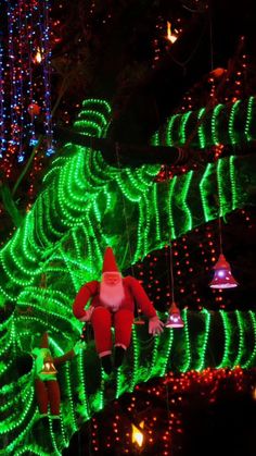 christmas lights in the shape of santa claus on a tree with green and red lights