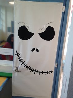 a classroom door decorated to look like the face of jack skellingy from the nightmare