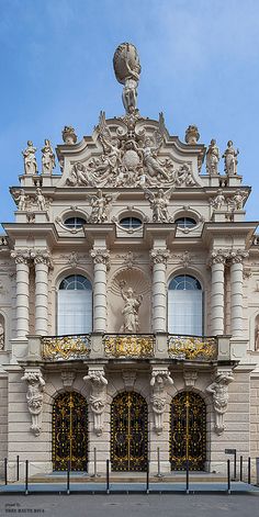 an old building with statues on the front