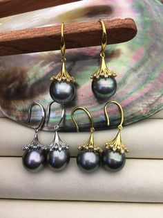 "pearl quantity: 1 pair pearl size: 11-12mm--width,it's big metal: sterling silver metal color: Gold or Silver  pearl luster: high luster pearl grade: AA+ pearl shape: drop pearl color: natural gray green ----------------American Wire Gauge to Diameter mm-------------- 28Gauge=0.32mm 27Gauge=0.361mm 26Gauge=0.404mm 25Gauge=0.455mm 24Gauge=0.511mm 23Gauge=0.574mm 22Gauge=0.643mm --select 0.7mm hole or big 21Gauge=0.724mm 20Gauge=0.813mm --select 0.9mm hole or big 19Gauge=0.912mm  18Gauge=1.024mm 17Gauge=1.151mm 16Gauge=1.29mm  --select 1.3mm hole or big 15Gauge=1.45mm  --select 1.5mm hole or big 14Gauge=1.628mm --select 1.8mm hole or big 13Gauge=1.829mm 12Gauge=2.052mm --select 2.2mm hole or big 11Gauge=2.304mm --select 2.5mm hole or big 10Gauge=2.588mm --select 2.8mm hole or big 9Gauge=2.9 Tahitian Pearl Wedding Jewelry, Elegant Tahitian Pearl Drop Earrings, Elegant Tahitian Pearl Earrings For Anniversary, Elegant Tahitian Pearl Earrings For Wedding, Silver Round Tahitian Pearl Earrings, Silver Tahitian Pearl Round Earrings, Tahitian Pearl Round Earrings For Wedding, Tahitian Pearl Drop Earrings, Round Tahitian Pearl Earrings For Wedding