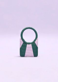 Fitzacat 0.5 is our mini tote crafted in frosted lavender & sacramento green vegan leather radial panels. accentuated with metal trims and our signature spidey handle. Comes with a chain-link strap. Green Bag With Detachable Round Handle, Green Bag With Detachable Strap And Round Handle, Chic Green Bag With Round Handle, Green Bag With Round Handle For Everyday Use, Green Bag With Round Handle For Daily Use, Green Shoulder Bag With Round Handle For Everyday, Everyday Green Shoulder Bag With Round Handle, Modern Green Shoulder Bag With Round Handle, Sacramento Green