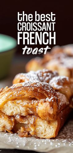 the best croissant french toast with powdered sugar on top and text overlay that reads, the best croissant french toast