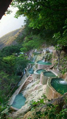 there are many small pools in the mountains with steps leading up to them that lead down into the water