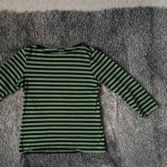 "Vintage Marimekko classical cotton jersey  3/4 sleeve top. Black and green stripes. Made in Finland, MARIMEKKO ♥ Materials - 100 % cotton jersey                        ♥ Women Size- S Measured flat -  Shoulder seam to shoulder seam- 37cm (14.5\") Armpit to armpit - 43cm (16.9\") Length - 57cm (22.4\") It is in very good vintage condition. .   Real colours may be little different from their appearance on your display. Pleas look at the pictures carefully and i will be happy to answer all of your Green Long Sleeve Tops With Contrast Stripes, Green Horizontal Stripe Crew Neck Top, Spring Green T-shirt With 3/4 Sleeve, Green Cotton Top With 3/4 Sleeve, Green Casual T-shirt With 3/4 Sleeve, Vintage Marimekko, Three Quarter Sleeve Tops, Top T Shirt, Marimekko